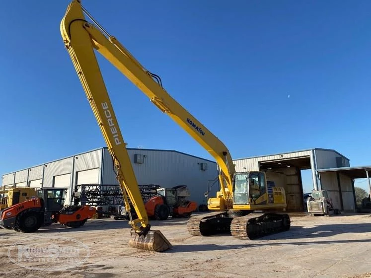 Used Komatsu excavator under blue sky
